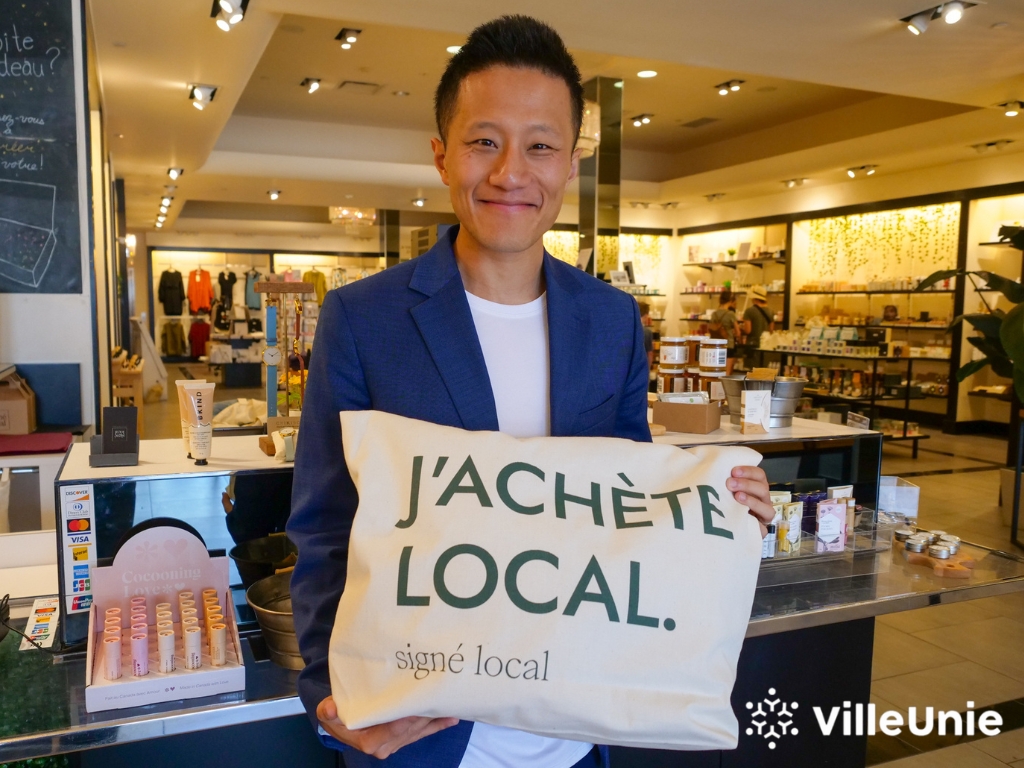 business man holding tote bag supporting local shopping